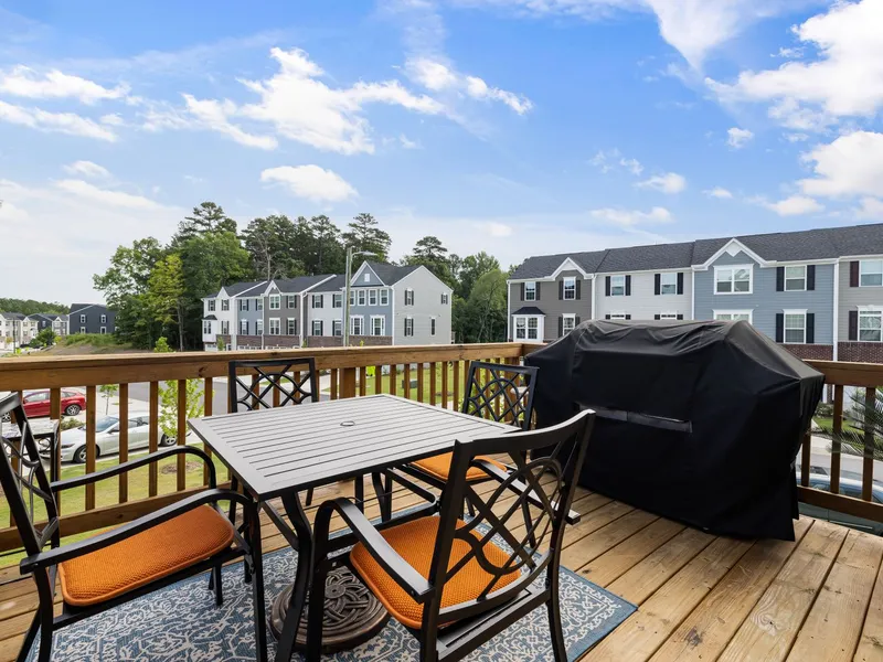 Elevated wood deck with railing and outdoor seating