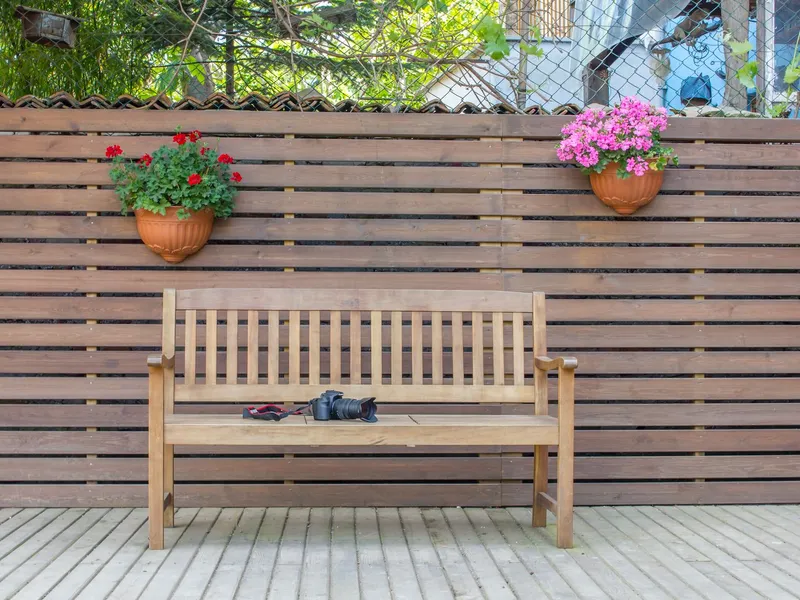 Horizontal wood privacy fence along a deck edge