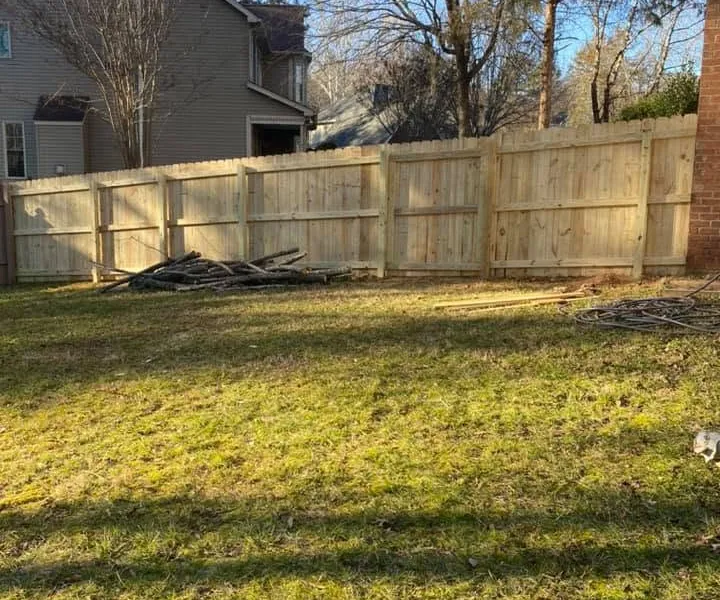 New wood privacy fence installed across a residential backyard