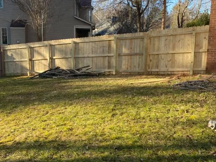 New wood privacy fence installed across a residential backyard